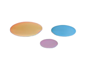 three flat disks of semiconductor laser diode wafer material, on blue, one gold, one pink