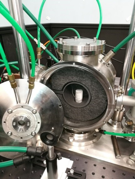 image of an experimental setup with a prism within a furnace within a cooled chamber