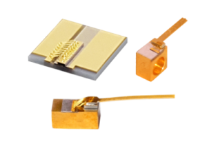 2 brass and one gold colored laser diode packages, flat substrate, rectangular block and skinny cube with a through hole