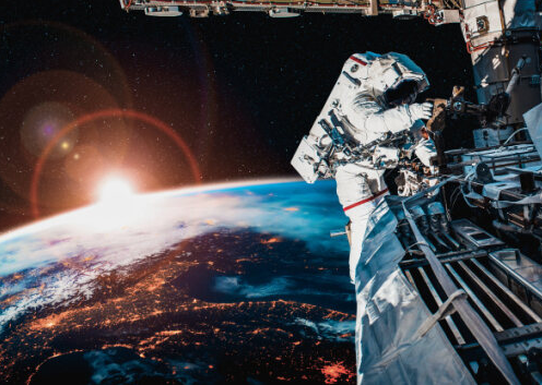 space-based oem laser solutions, astronaut on a 'moon walk' on a space station orbiting earth, full image