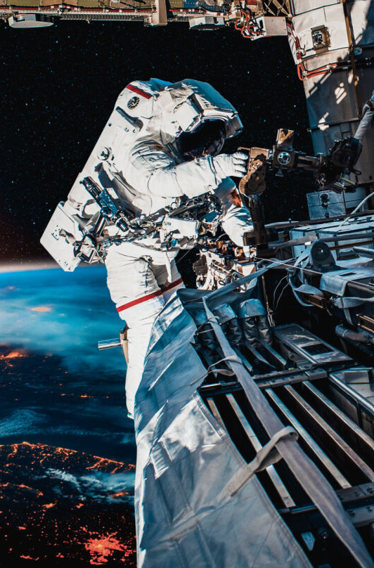 space-based oem laser solutions, astronaut on a 'moon walk' on a space station orbiting earth, trimmed